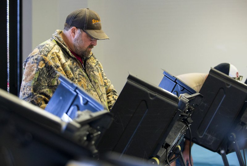 Greg Kendrick of Springdale casts his ballot Friday at the Rogers-Lowell Area Chamber of Commerce in Lowell.