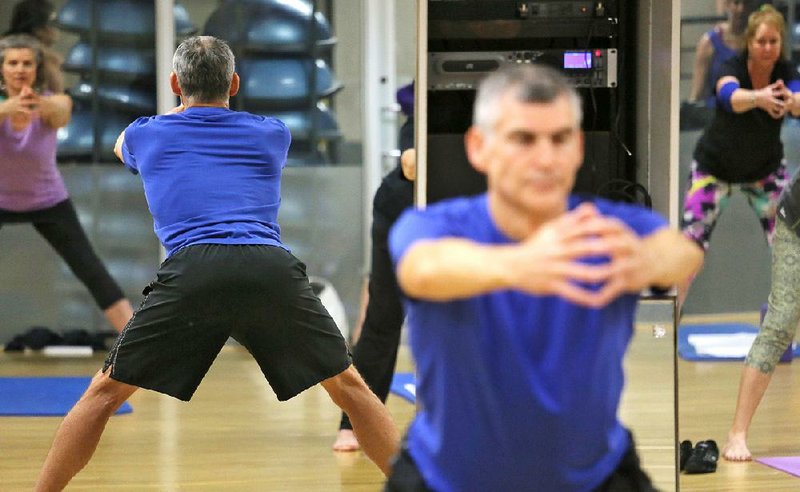 Teaching his class at Little Rock Athletic Club, Pat Riley does the founder, a basic isometric exercise used in Foundation Training to develop muscular endurance in the lower back at the very angles where less careful posture results in pain.