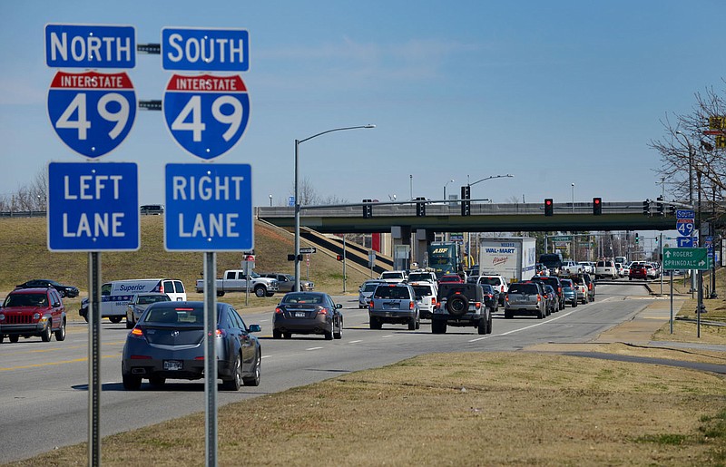 FILE — Traffic moves along at the intersection of S.E. Walton Boulevard/W. Walnut Street and Interstate 49 at the city limits of Bentonville and Rogers in this Feb. 26, 2016 file photo. (NWA Democrat-Gazette/BEN GOFF)