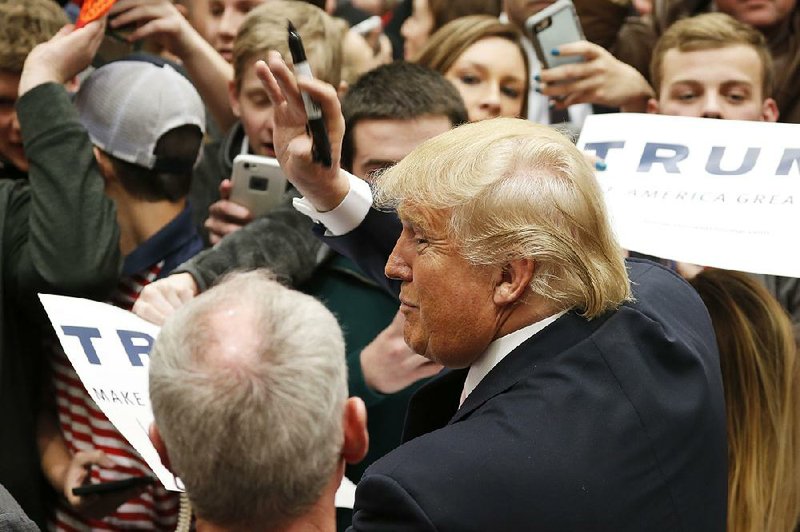 Republican presidential candidate Donald Trump signs autographs during a rally at Radford University on Monday in Radford, Va.