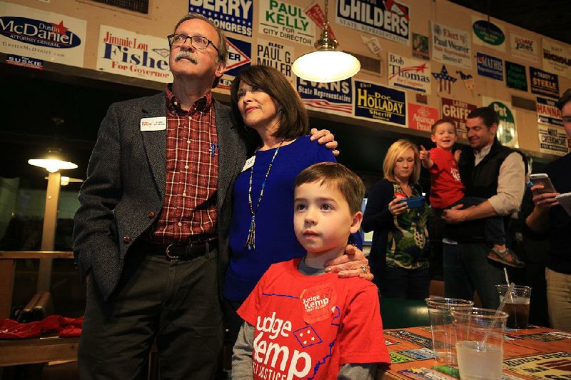 Dan Kemp watches the returns Tuesday night with his wife, Susan, and grandson Hoover Brogdon, 6, at an election party in Little Rock shortly after being declared the winner in the race for state Supreme Court chief justice.