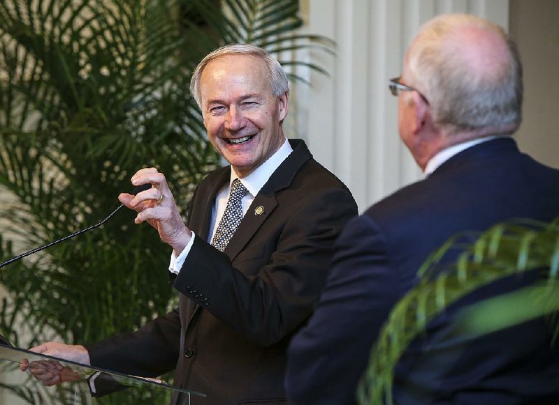 FILE — Gov. Asa Hutchinson takes a question from Rex Nelson (right) about whether he would actively campaign for Donald Trump if Trump wins the GOP presidential nomination in this March 3, 2016, photo. While not committing to that at the time, Hutchinson said Trump needs to shift “his demeanor” and comments to gain the support of “the establishment.” 