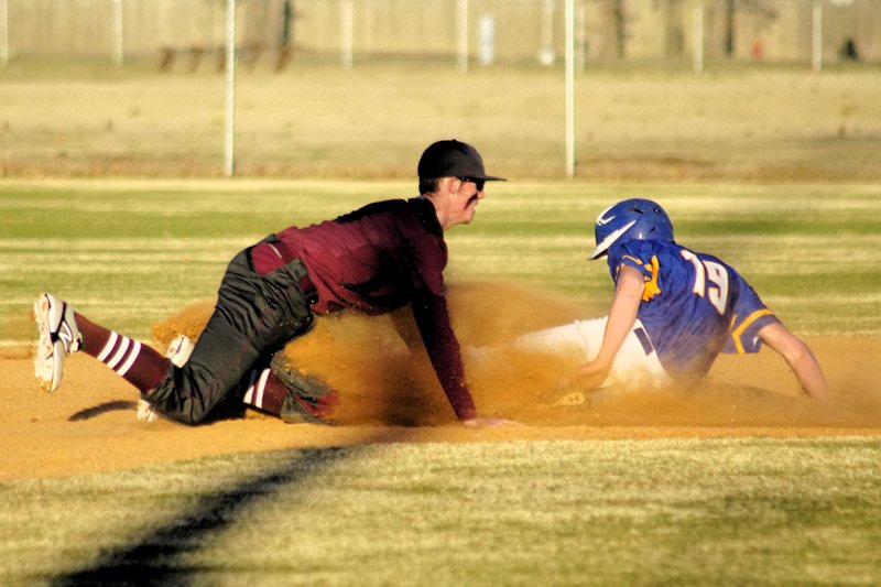 Tanner Shipp, Gentry short stop, tags out a Cedarville base runner attempting to steal second on Tuesday in the Merill Reynolds Memorial Complex in Gentry.