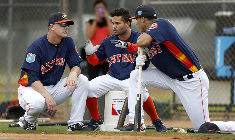 In this Feb. 23, 2016, file photo, Houston Astros manager A.J. Hinch, left, and Astros' Jose Altuve and Carlos Correa chat during a workout at the Astros spring training camp in Kissimmee, Fla. Altuve is one of only a handful of remaining Astros who endured the team's rebuilding project. 