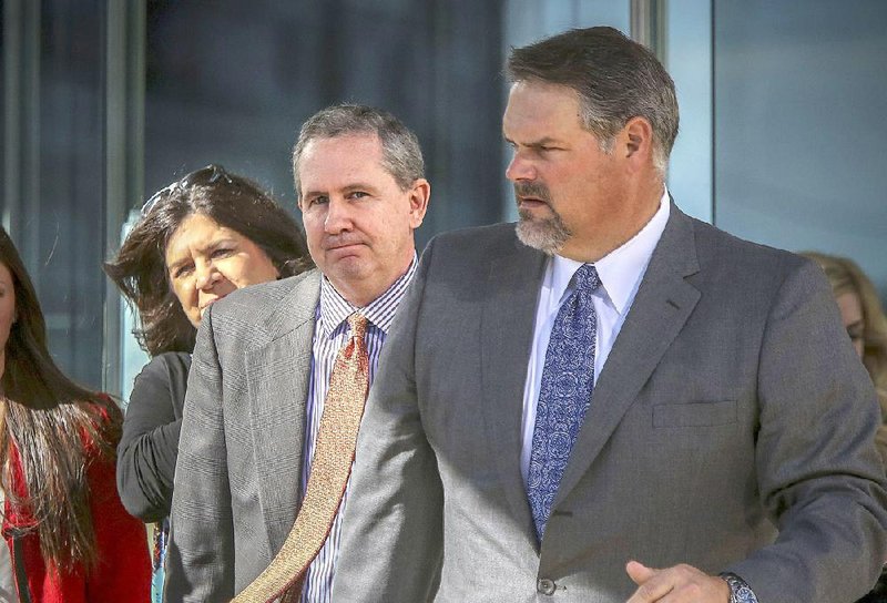 Former state Sen. Paul Bookout (center) leaves court in 2016 in Little Rock with his family and his attorney, Bill Stanley (right). 