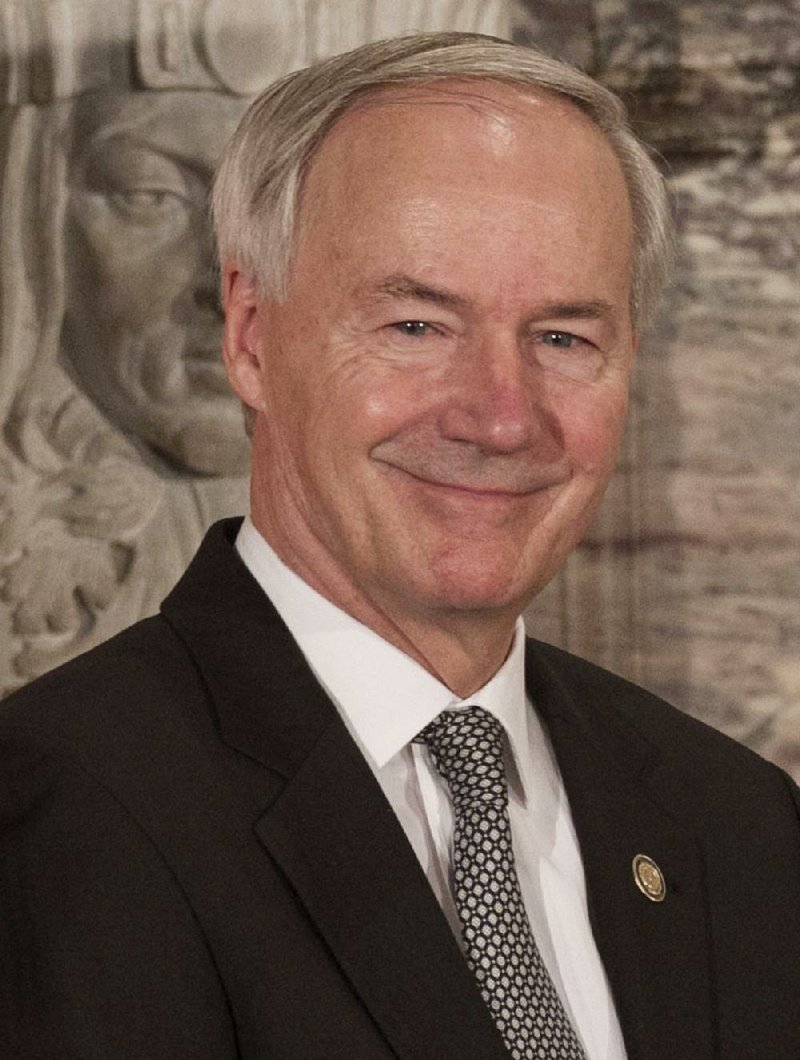 Gov Asa Hutchinson speaks at a press conference.