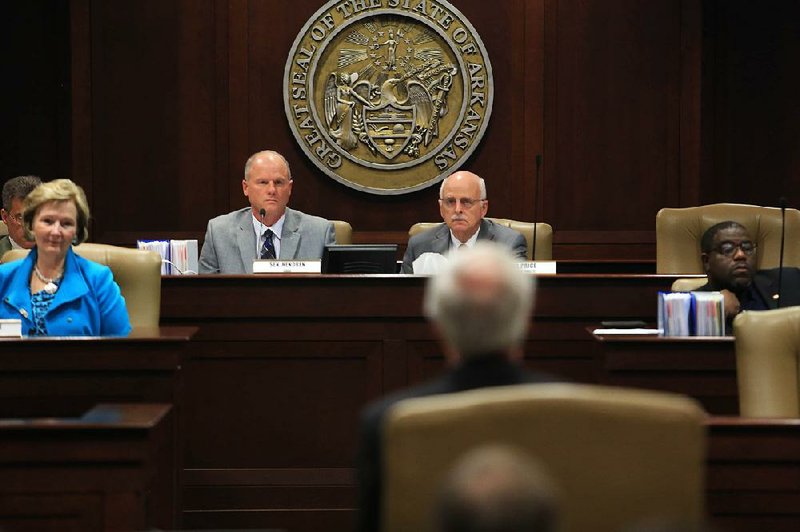 Committee Chair Sen. Jim Hendren, R-Gravette (left center)listens to Gov. Asa Hutchinson address the Health Reform Legislative Task Force.