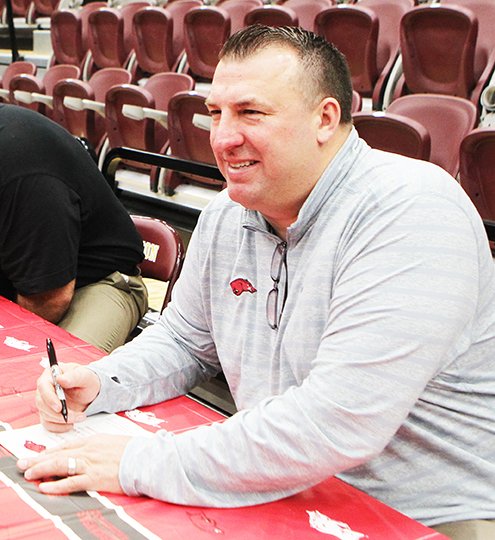 The Sentinel-Record/Richard Rasmussen COACH TALK: Razorback football coach Bret Bielema signs autographs at the spring rally of the Roy L. Murphy Razorback Club Monday night at Lake Hamilton Wolf Arena.