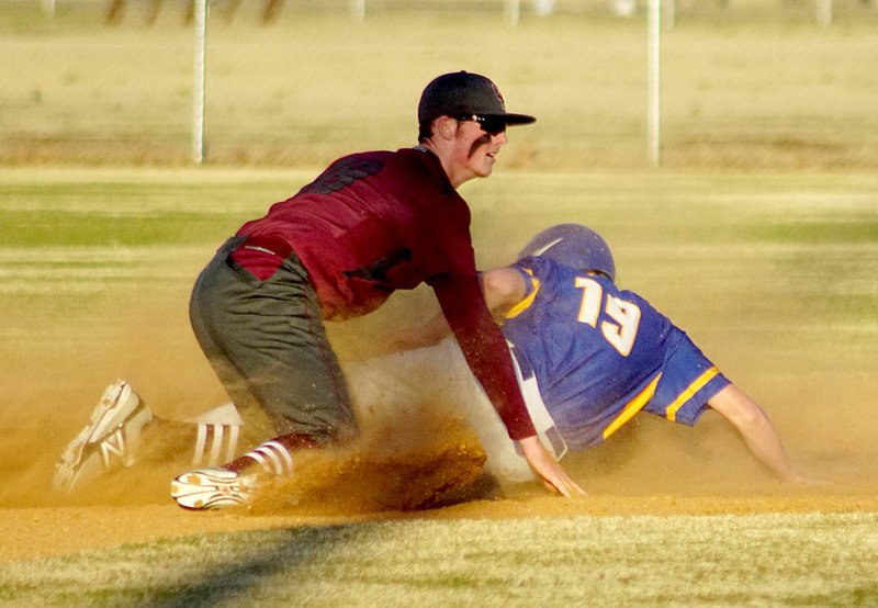 Photo by Randy Moll Tanner Shipp tags out a Cedarville runner at second during Gentry&#8217;s season opener against Cedarville on Tuesday, March 1, 2016, in the Merrill Reynolds Memorial Complex.