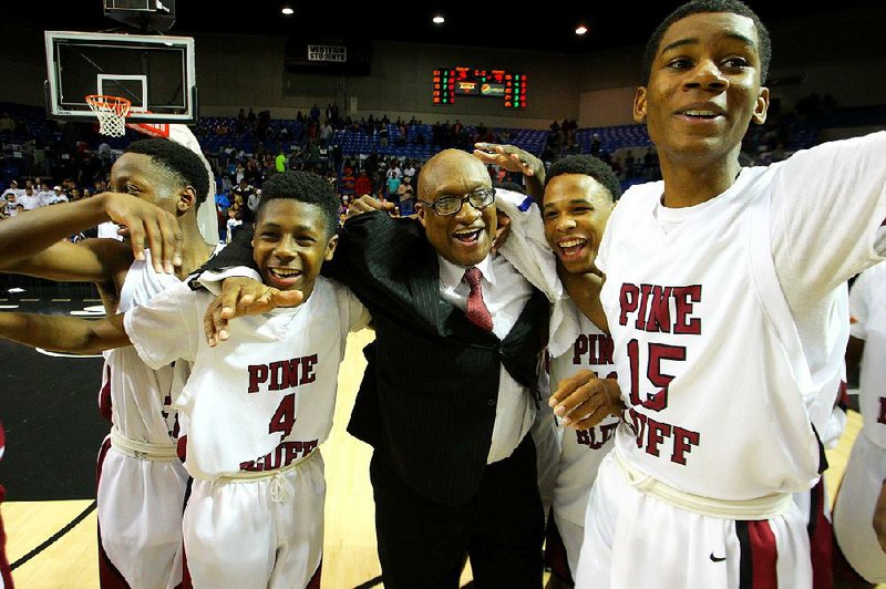 Pine Bluff Coach Clarence Finley (center) celebrates with his team following last year’s Class 6A championship victory over Jonesboro. To win the title again this year, Finley must defeat a familiar opponent in Little Rock Parkview.