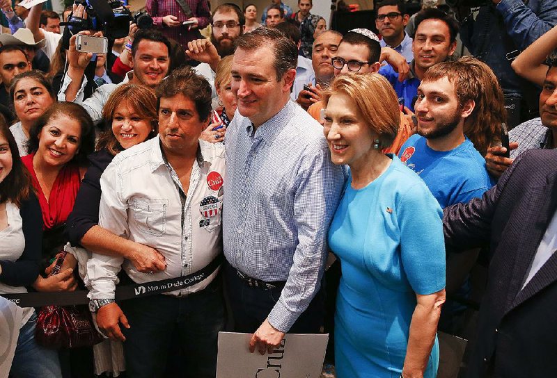 Republican presidential candidate Sen. Ted Cruz, R-Texas, and former candidate Carly Fiorina pose for photographs Wednesday during a campaign rally in Miami.