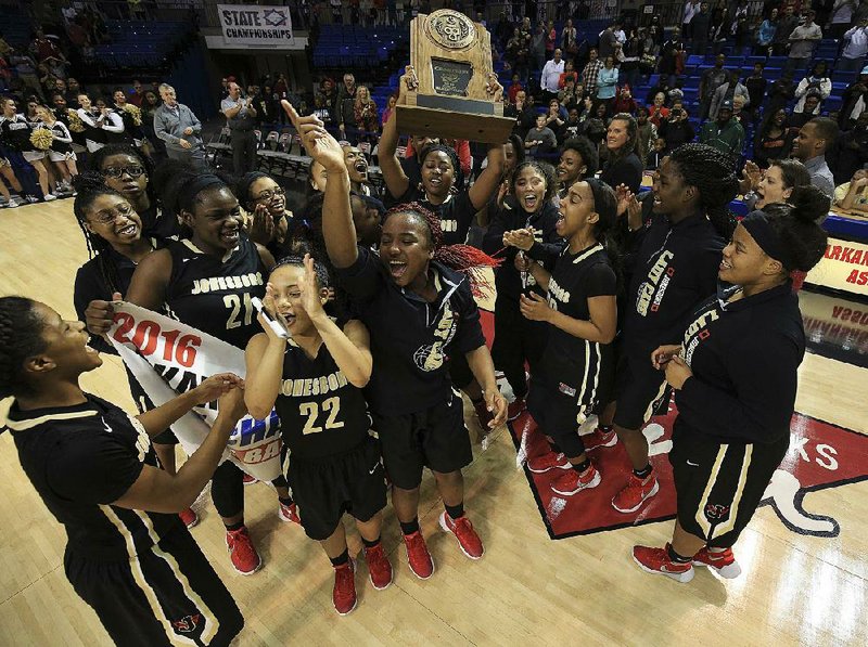 Member of Jonesboro’s girls basketball team celebrate after beating Russellville 50-43 Thursday to win the Class 6A girls basketball state championship at Bank of the Ozarks Arena in Hot Springs. It was Jonesboro’s first state title, earned in the team’s first trip to the state final.