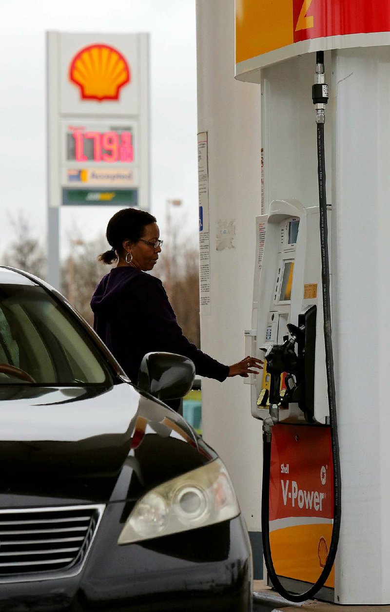 motorist prepares to pump gas for $1.79 a gallon Thursday at a Shell station in North Little Rock.