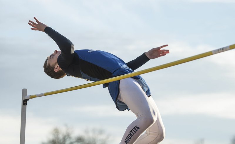 Jake Benninghoff of Rogers High clears the bar Thursday during the high jump at the Panther Relays at Glen Black Stadium in Siloam Springs. Benninghoff won, clearing 6’4”.