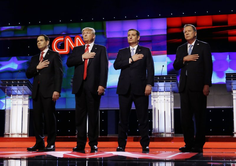 Republican presidential candidates, Sen. Marco Rubio, R-Fla., left, Donald Trump, Sen. Ted Cruz, R-Texas, and Ohio Gov. John Kasich, right, stand together during the signing of the National Anthem, before the start of the Republican presidential debate sponsored by CNN, Salem Media Group and the Washington Times at the University of Miami, Thursday, March 10, 2016, in Coral Gables, Fla. (AP Photo/Wilfredo Lee)