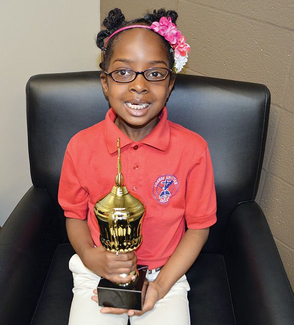 Sydney Hopson, 7, of Conway holds a trophy she won last weekend at a talent show in West Memphis. She received first place in the children’s division for her recitation of Bible verses, as well as singing hymns. She is a first-grader at Conway Christian Elementary School.