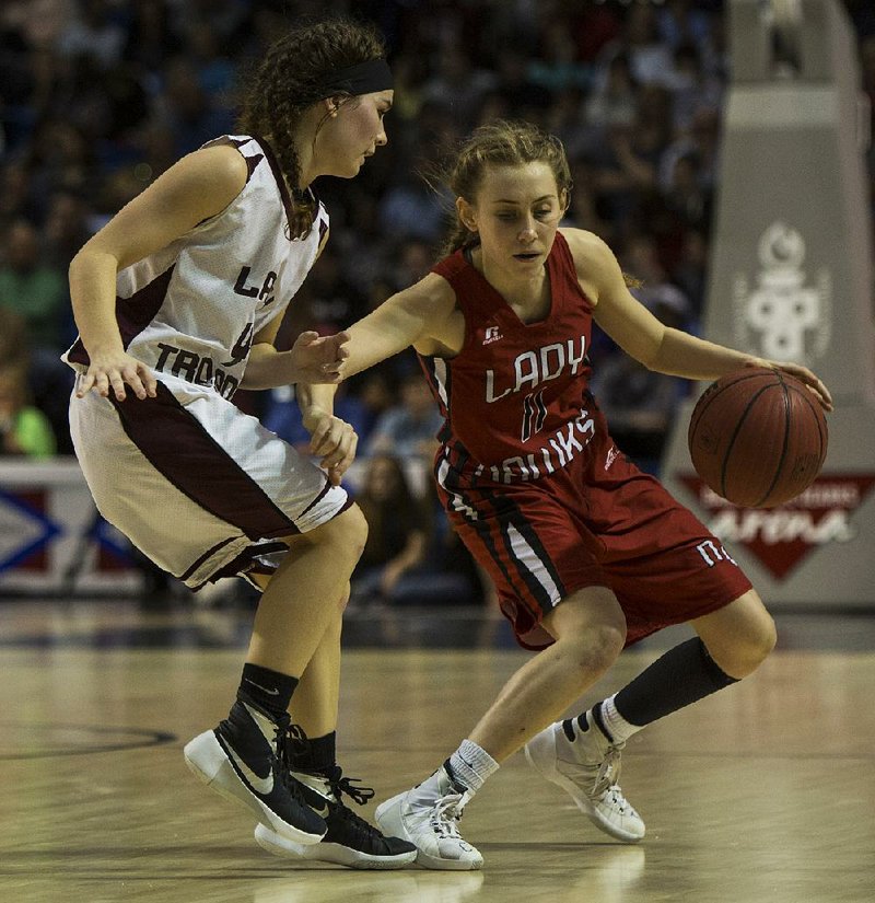 Nemo Vista’s Jacie Andrews works her way past Kirby’s Taylor Swanson during the fourth quarter of the Class 1A state championship game at Bank of the Ozarks Arena in Hot Springs. Andrews finished with six point to help the Lady Hawks beat the Lady Trojans 47-36.