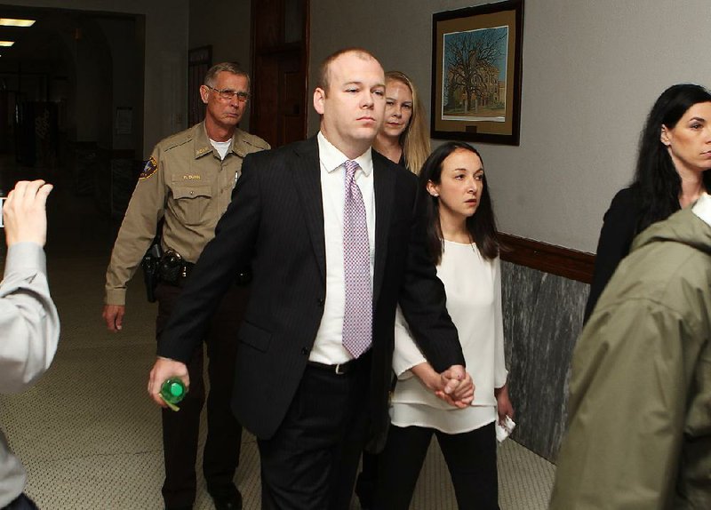 Suspended Garland County Circuit Judge Wade Naramore and his wife, Ashley, leave the Garland County Courthouse on Friday.