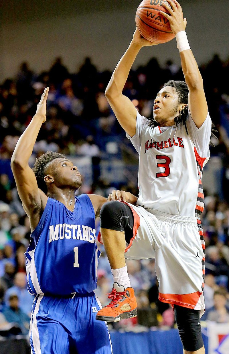 Maumelle’s Shawn Williams (right) goes up for a shot against Forrest City defender R.J. Glasper during the Class 5A boys state championship game Saturday. Williams fi nished with 44 points, the second-most in a state championship game. Glasper, who was named the Class 5A tournament MVP, finished with 40.