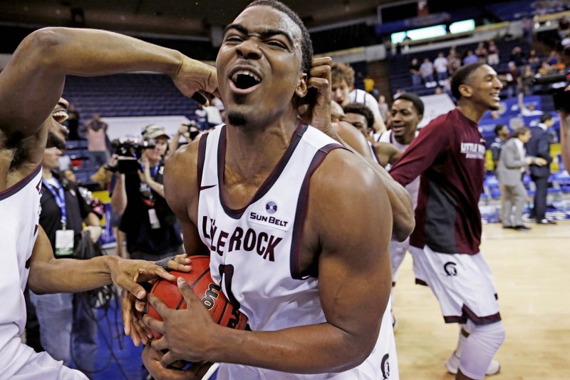 UALR forward Roger Woods (0) celebrates the win over Louisiana Monroe with his teammates at the conclusion of an NCAA college basketball game in the championship of the Sun Belt Conference men's tournament in New Orleans, Sunday, March 13, 2016. Arkansas Little Rock defeated Louisiana Monroe 70-50. (AP Photo/Max Becherer)
