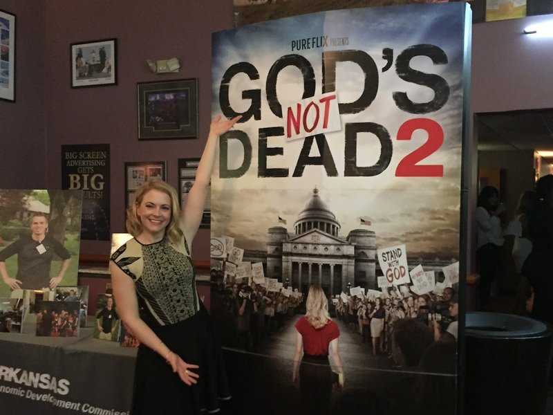Melissa Joan Hart, lead actor in "God's Not Dead 2," stands Monday, March 14, 2016, in front of a poster promoting the faith-based film at its Little Rock private screening at Riverdale 10 Cinema.