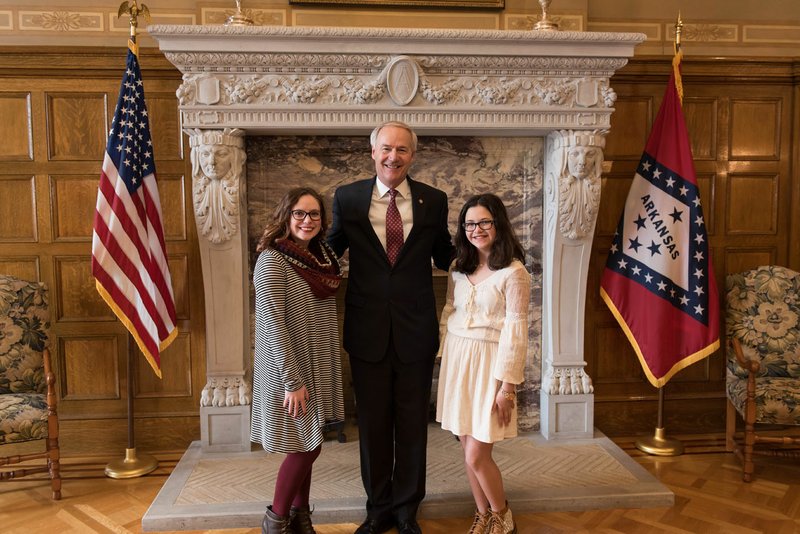 Photo by Randall Lee Emma Russell, left, ninth grader at Gravette High School, and Maddie Mitchell, eighth grader at Gravette Middle School, met with Governor Asa Hutchinson Feb. 24 in Little Rock. The girls were both silver medalists in the FFCLA State Star events the next day.