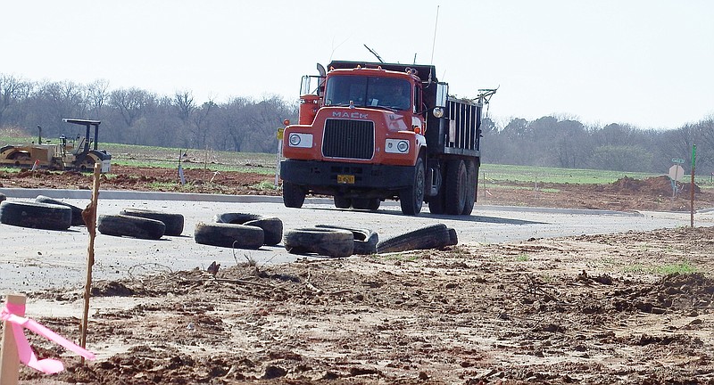 TIMES photograph by Annette Beard A truck hauls debris on Elkhorn Ridge subdivision, the final plat of which was tabled at a special Planning Commission meeting Monday night.
