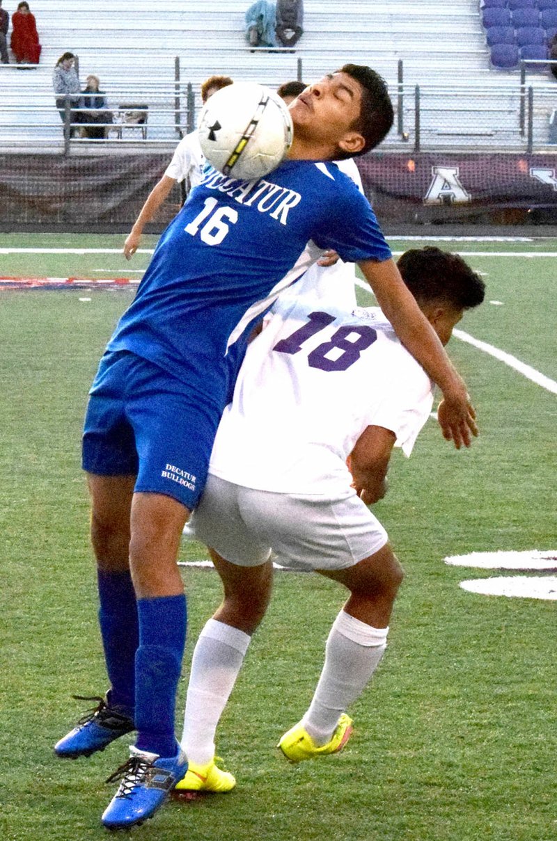 Photo by Mike Eckels Marck Guadarrama (Decatur #16) uses his chest to deflect the ball away from a Fayetteville shooter during the Decatur-Fayetteville soccer match at Harmon Play Field in Fayetteville March 10.