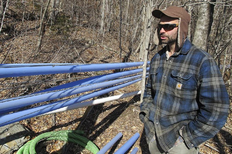 Mike Chiberton, general manager of Crown Maple’s southern Vermont operation, stands near sap and vacuum lines connected to maple trees in Sandgate, Vt. 
