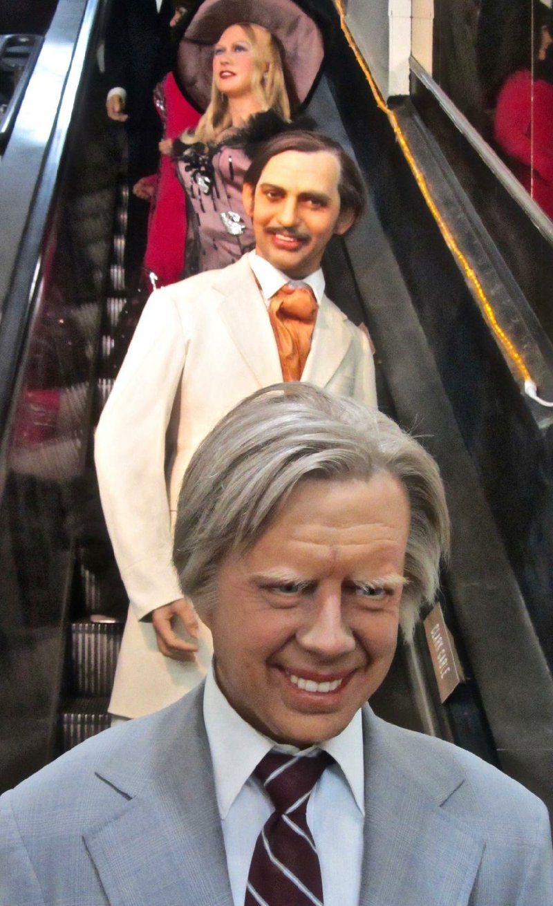 Effigies of Jimmy Carter, Clark Gable and Mae West pose on a disused escalator at Josephine Tussaud Wax Museum in Hot Springs. 