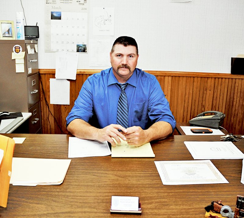 The Sentinel-Record/Mara Kuhn BACK AT WORK: Mountain Pine Police Chief Chad King works in his office Wednesday, after returning to work following the fatal shooting of a parolee in January.