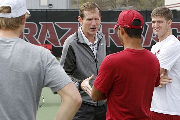 Arkansas coach Andy Jackson, center, talks to players during practice Wednesday, March 16, 2016, at Dills Tennis Center in Fayetteville. 