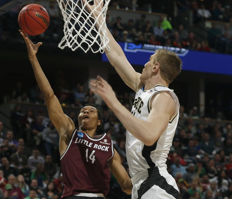 University of Arkansas at Little Rock forward Mareik Isom, left, drives for a shot as Purdue center Isaac Haas defends in the first half of a first-round men's college basketball game Thursday, March 17, 2016, in the NCAA Tournament in Denver. 
