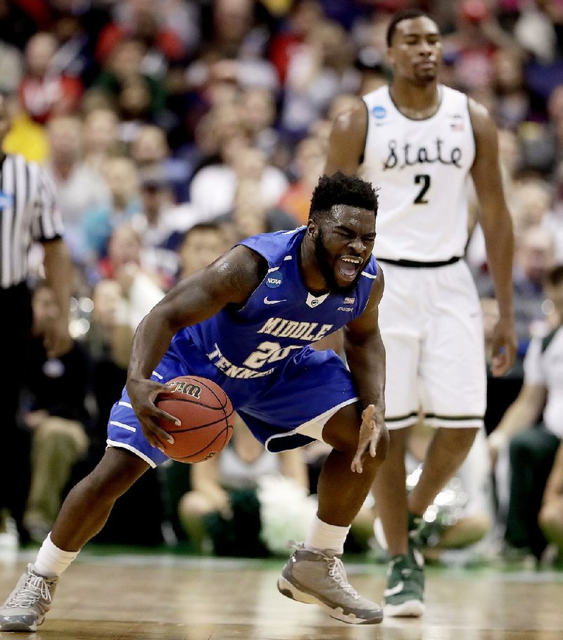 Middle Tennessee’s Giddy Potts celebrates late in the Blue Raiders’ victory over No. 2 seed Michigan State in the NCAA Tournament at St. Louis on Friday. It was the eighth time a No. 15 seed has won a first-round game since the field expanded to 64 teams in 1985.