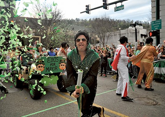 The Sentinel-Record/Mara Kuhn GREEN FUN: The International Order of Irish Elvi shoot confetti guns on Bridge Street Thursday during the First Ever 13th Annual World's Shortest St. Patrick's Day Parade. The Elvis impersonators have become one of the mainstays of the parade.