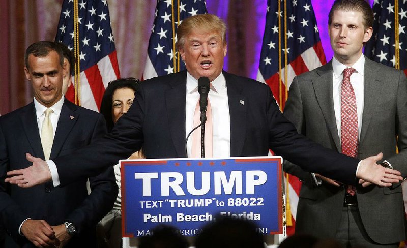 Republican presidential candidate Donald Trump speaks to supporters at his primary election night event at his Mar-a-Lago Club in Palm Beach, Fla., Tuesday, March 15, 2016. At right is his son Eric Trump and at left is campaign manager Corey Lewandowski.