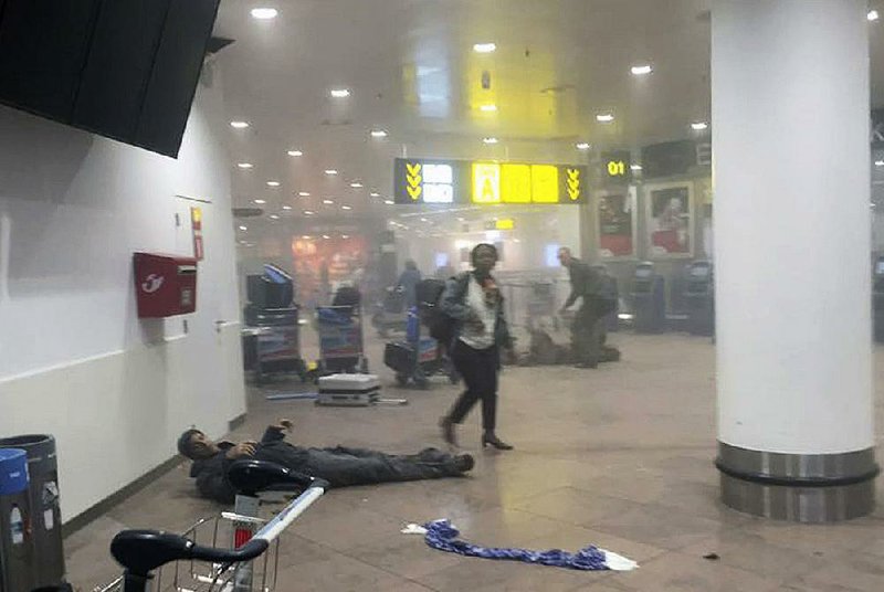 As travelers move through the smoke-filled Belgian airport after Tuesday’s attack, Brazilian basketball player Sebastien Bellin, a former member of the Belgian national team, lies wounded. “What we feared has happened,” Belgian Prime Minister Charles Michel said.