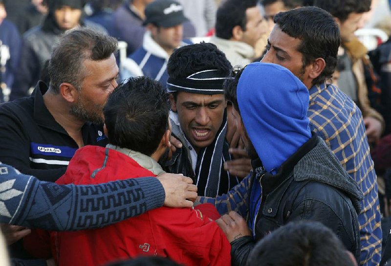 At the Greek border station of Idomeni, migrants fight Tuesday during a protest demanding the opening of the border between Greece and Macedonia. 