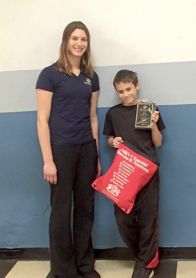 Photo by Ben Onnen Jonah Waits (right) of Gravette, was honored as Youth of the Year for the Gravette Boys and Girls Club at the annual banquet held Feb. 23. He is shown here displaying the Youth of the Year plaque and bag of prizes he was awarded. He is shown with Ashley Oosterman, director of the Gravette Unit.