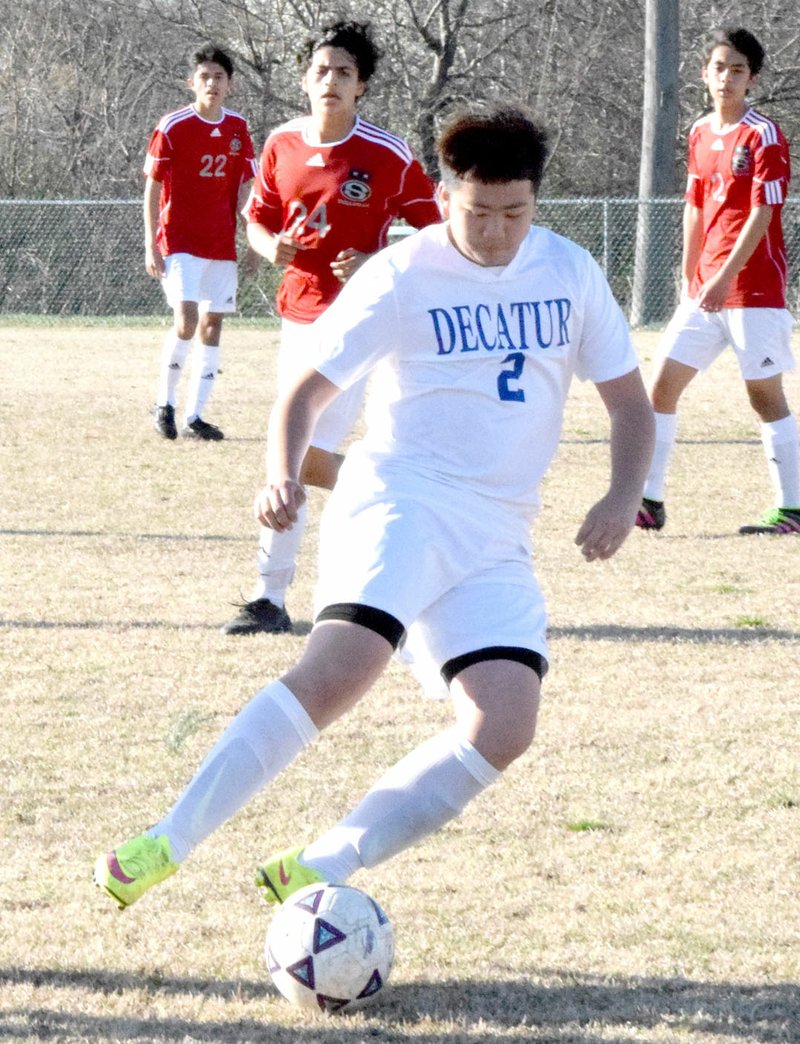 Photo by Mike Eckels Decatur&#8217;s Alex Lee (2) gains control of the ball during the Springdale-Decatur non-conference soccer match at Bulldog Stadium in Decatur March 14. The Springdale Bulldogs took the victory, 5 to 1.