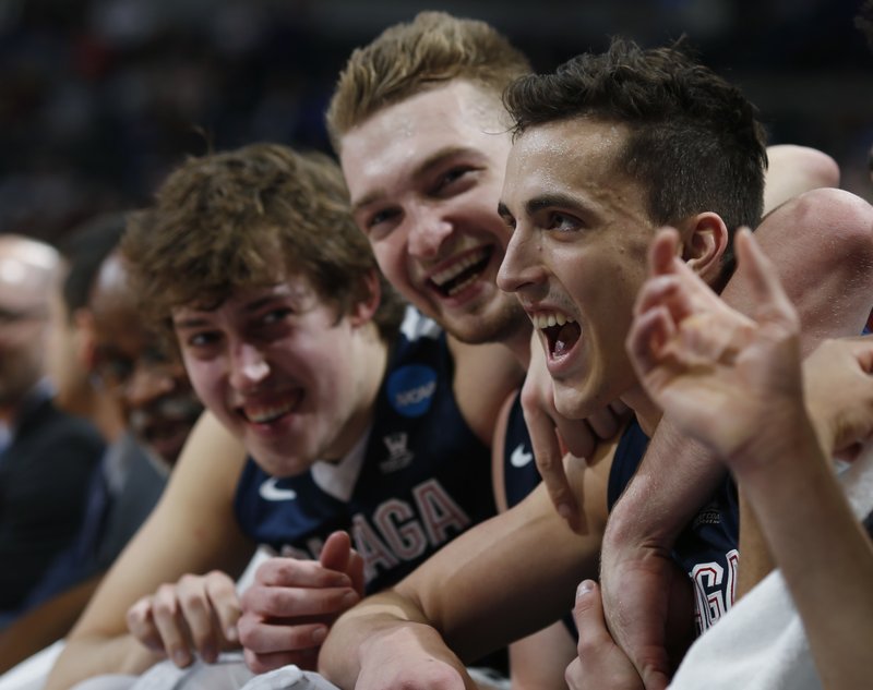 From front, Gonzaga guard Kyle Dranginis celebrates with forwards Domantas Sabonis and Kyle Wiltjer on the bench late in the second half of a second-round men's college basketball game against Utah, Saturday, March 19, 2016, in the NCAA Tournament in Denver. 