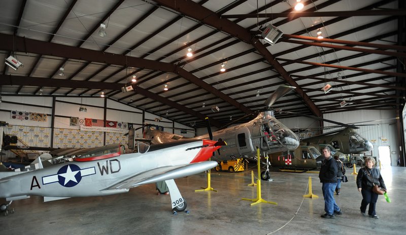 
Visitors check out a P-51 Mustang replica Saturday, March 19, 2016, at the Arkansas Air and Military Museum in Fayetteville. The museum is planning a fundraising effort in the coming months to fund repairs and renovations for its World War II-era wooden hangar and to connect its two main buildings.