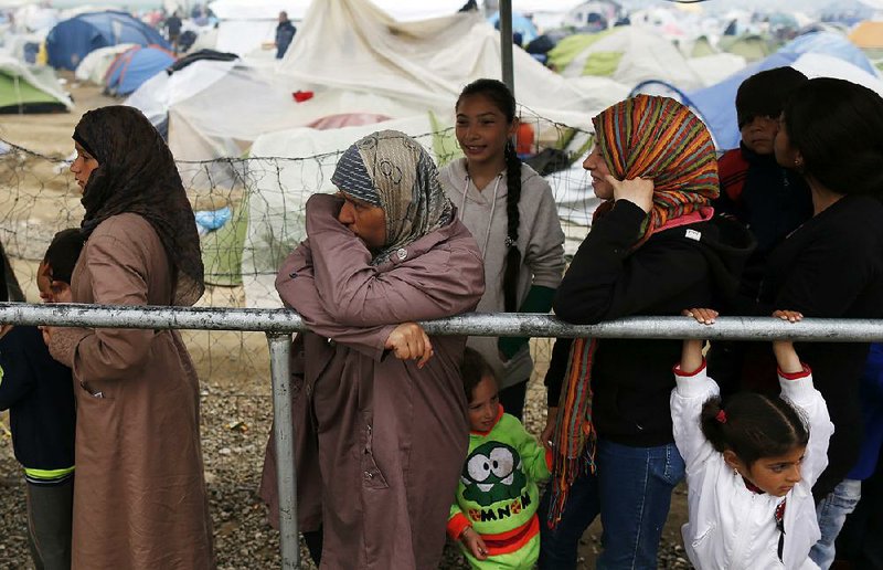Migrants at a camp in Idomeni, Greece, wait for food on Wednesday. 