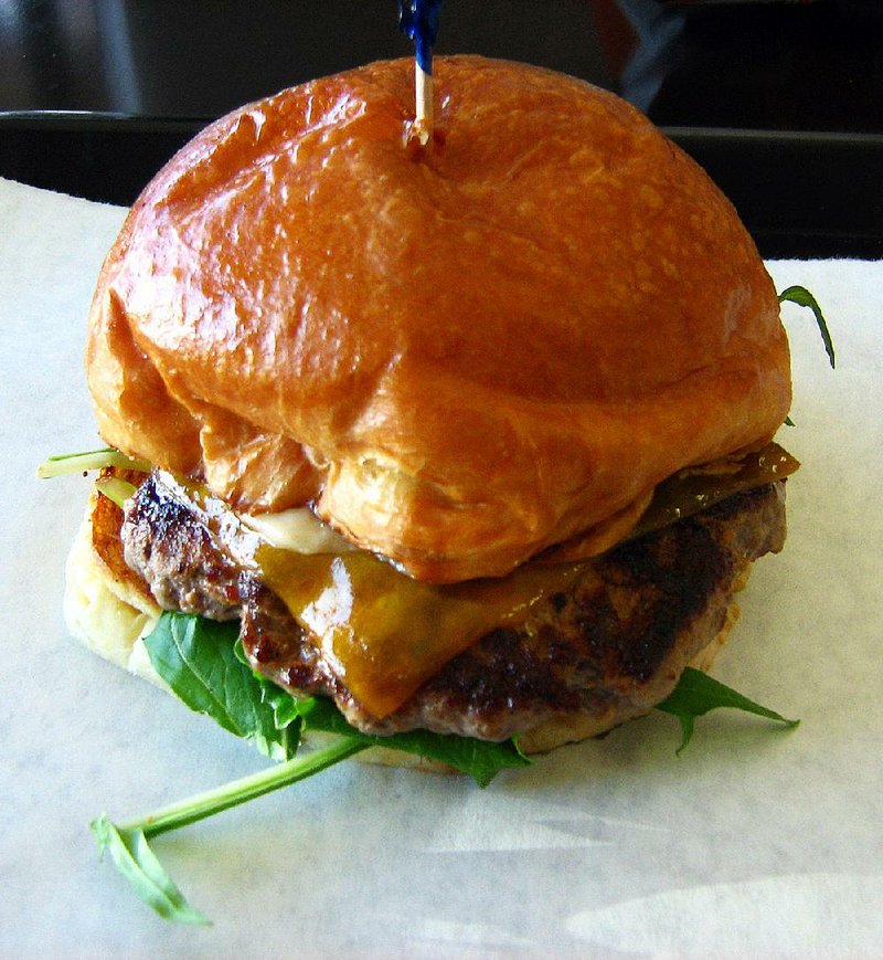 The Burger at Arkansas Fresh Cafe in Bryant is topped with cheese, greens and garlic mayonnaise, and it’s served on a fluffy brioche bun. 