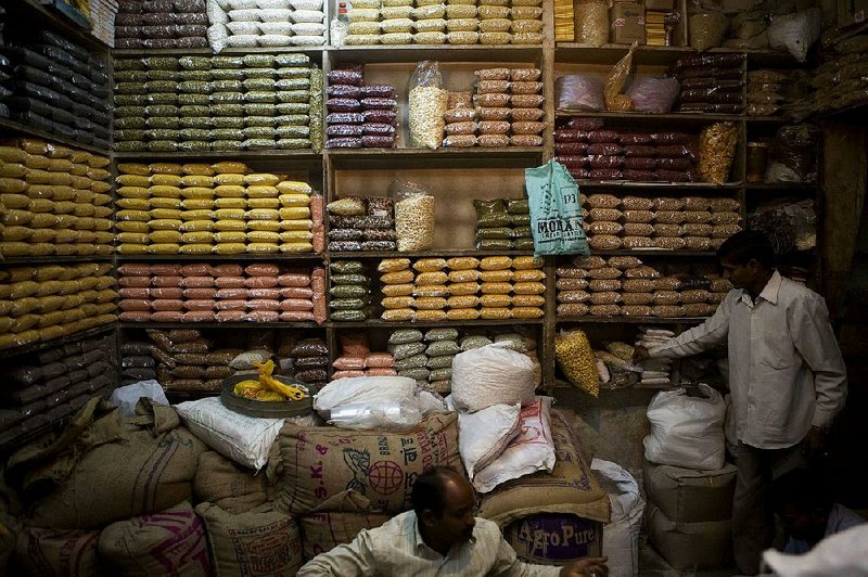 An assortment of grains, soybeans, chickpeas, lentils and kidney beans are stacked on shelves at a market in New Delhi in this file photo. Asian demand for pulses — plants harvested for their dry seeds — is leading to increased plantings in Canada and the United States. 