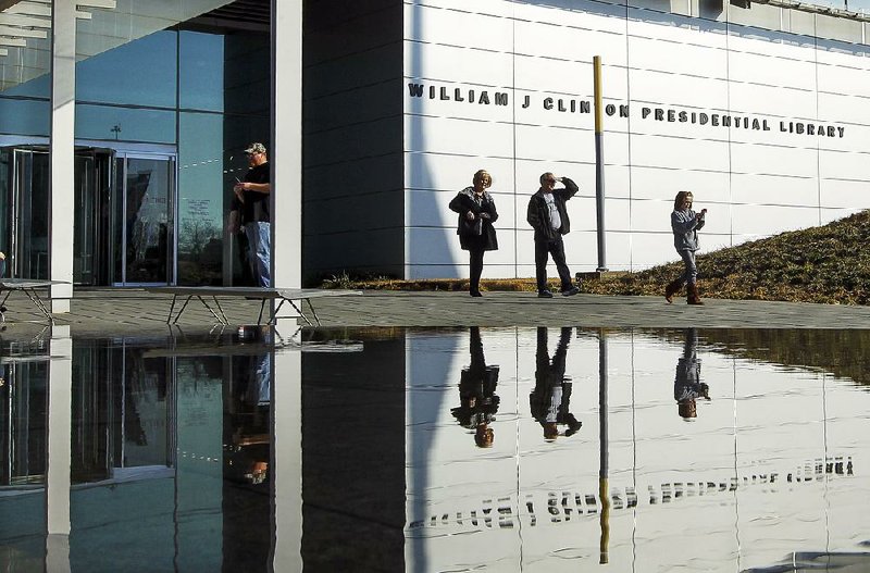 Visitors stand near the entrance to the Clinton Presidential Center in this file photo. Pulaski and Garland counties in central Arkansas led the state in generating tourist dollars in 2015, according to a report released last week by the state Department of Parks and Tourism. 