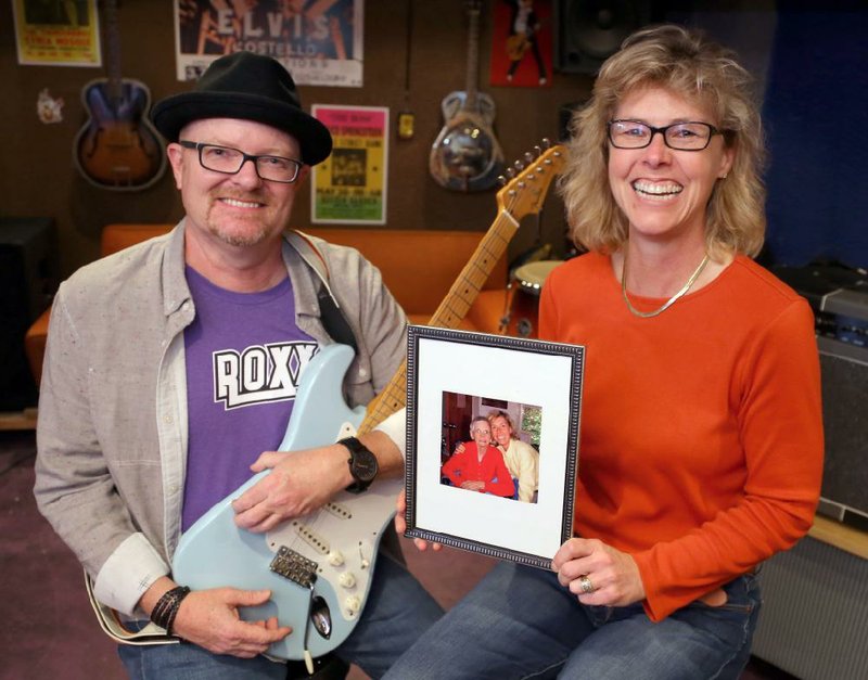 Stephenie Cooke (right) holds a picture of herself and her grandmother. Her grandmother’s diagnosis of Alzheimer’s disease helped spark the idea of Amp Out Alz. With the help of her friend David Rainwater, the fundraiser has become an annual event.