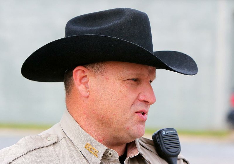 “I like the hat,” Pulaski County sheriff’s Deputy Ed Johnson says of his county-issued cowboy hats. “I wear one off-duty. It makes me feel better to put it on.”