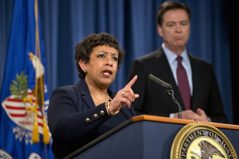 Attorney General Loretta Lynch, accompanied by FBI Director James Comey, speaks during a news conference at the Justice Department in Washington, Thursday, March 24, 2016.  