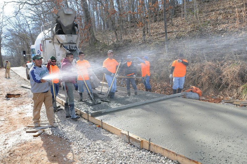 NWA Democrat-Gazette/FLIP PUTTHOFF Workers pour concrete Friday March 4, 2016 along the pedestrian-bicycle trail being built around Lake Atalanta.